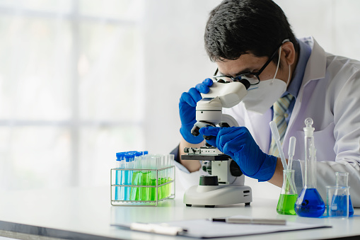 científico viendo microscopio
